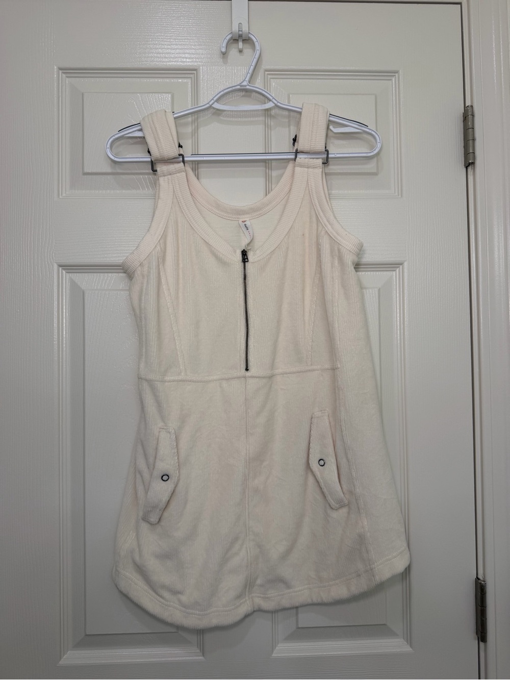 Sleeveless Cream Mini Dress with Front Zip and Pocket Tabs